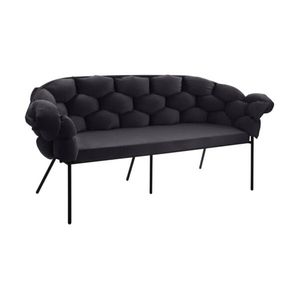 Curved, dark tufted sofa with multiple cushions and slender black metal legs, photographed from the front side view.