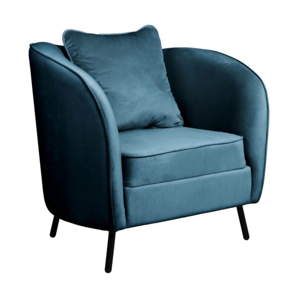 Close-up of a blue velvet upholstered chair with plush cushions and angled legs