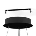 Close-up view of a black circular ceiling light fixture with metal supports and hanging cables